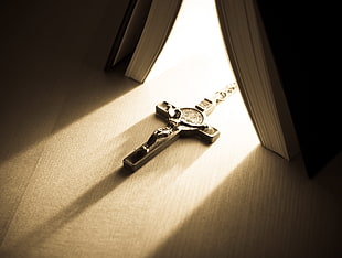 silver-colored crucifix pendant near book HD wallpaper